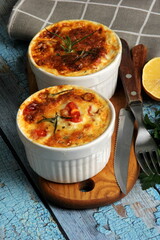 Cod casserole with cheese, sour cream and tomatoes. White fish casserole with cheese and sour cream, Baked fish on pot. Julienne of seafood