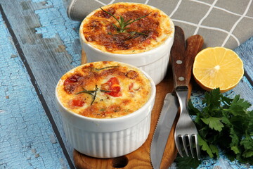 Cod casserole with cheese, sour cream and tomatoes. White fish casserole with cheese and sour cream, Baked fish on pot. Julienne of seafood