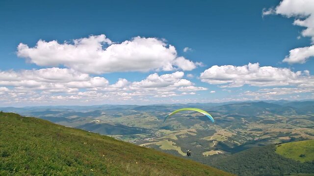Takeoff of paragliders from the top of the mountain