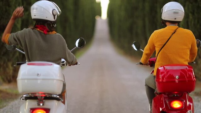 slow motion footage of young couple  on scooter enjoying in romantic road trip.