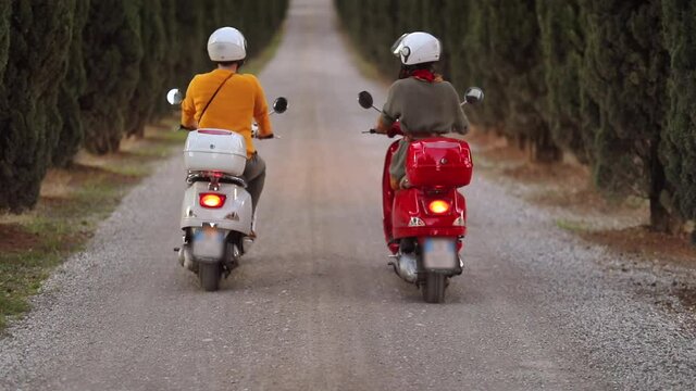slow motion footage of young couple  on scooter enjoying in romantic road trip.