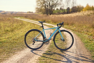 Cyclocross bike on a field, gravel road in sunny, clear weather.