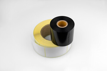 White roll of labels for thermal perforation and Ribbon, thermal transfer dye tape. Stickers for thermal or thermal transfer printing