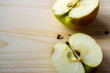 halves of an apple on a board