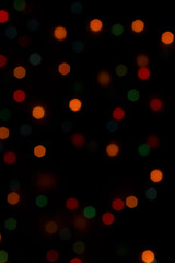 Colorful shiny bokeh lights. New year celebration lights. Cell phone wallpaper. Story background.