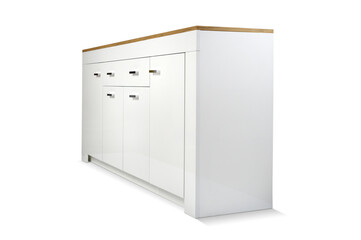 White chest of drawers on a light wall background. Side view