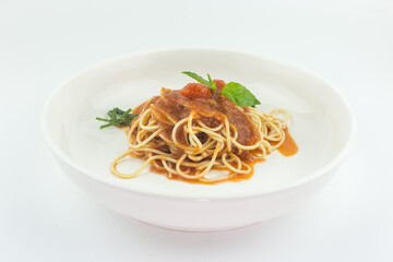 Spaghetti with tomato sauce in white plate on white background