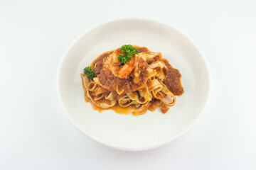 Pasta Fettuccine Bolognese with tomato sauce and prawns in white plate on white background