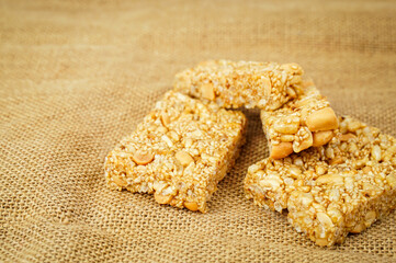 Traditional Thai dessert called Krayasart made from rice, nuts, sesame and sugar.Sack background.