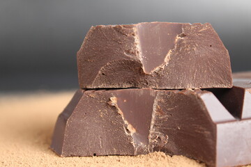 macro day chocolate two large chopped pieces of chocolate on a black background close-up