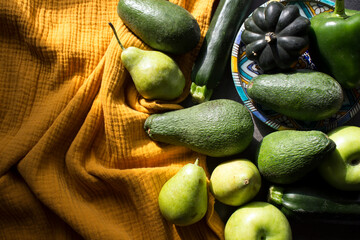 Still life with fresh organic vegetables and fruits. Yellow textured background. Healthy eating concept. 