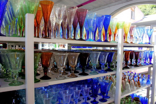 Biot Glass. Colorful glasses of french bubbles glass in the shop. Glassware in market for sale. Glassware buying luxury consumerism purchase sale retail discount offer price