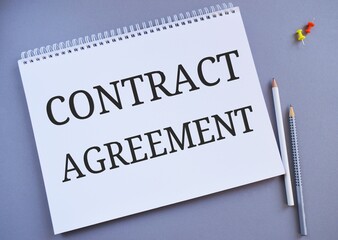 Contract agreement text written in Notebook.Gray background