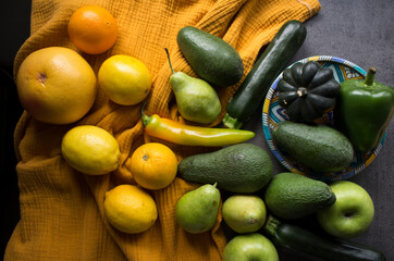 Still life with fresh organic vegetables and fruits. Yellow textured background. Healthy eating concept. 