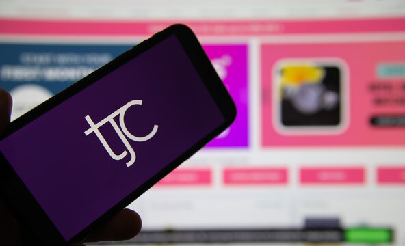 Viersen, Germany - February 9. 2021: Closeup of mobile phone screen with logo lettering of tele shopping channel tjc, blurred website background