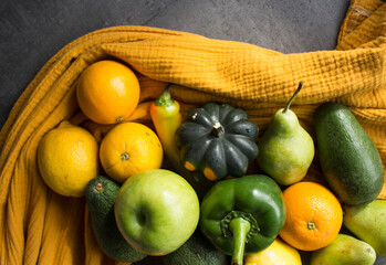 Fresh vegetables and fruits on a table. Organic pepper, apples, oranges, squashes, tomatoes, avocado, pears and lemons top view photo.  Seasonal vegetables and fruits top view. 