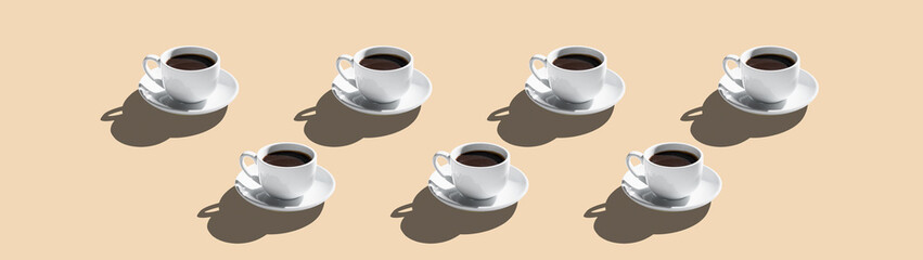 Set of white cups with coffee isolated on beige background banner