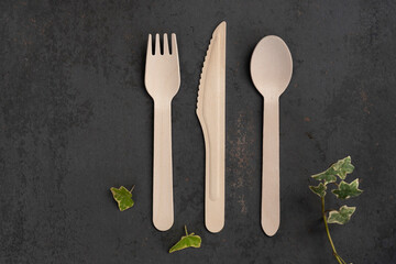 
wooden cutlery on dark stone