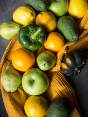 Fresh vegetables and fruits on a table. Organic pepper, apples, oranges, squashes, tomatoes, avocado, pears and lemons top view photo.  Seasonal vegetables and fruits top view. 