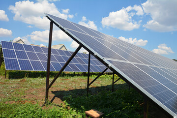 A close-up on ground mounted solar panels, home solar power station installed in the backyard of...