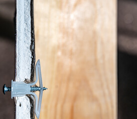 Side view of a drywall mount anchor and screw