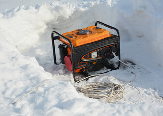 Usage of gasoline portable outdoor generator, home power generator to backup the house during blackouts, outages as a result of a winter storm.