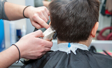 Men's haircut. The barber cuts the man. 