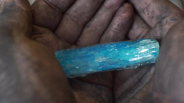 a large crystal lies in dirty male hands.close-up.shallow depth of field