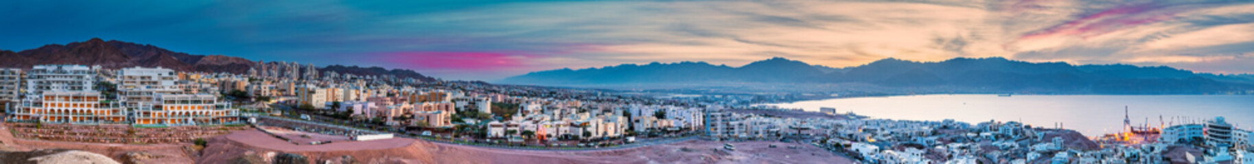 Aerial scenic panorama of the Red Sea, mountains and buildings of Eilat city - famous tourist resort and recreational place in Israel