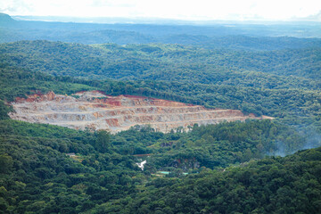 Mountain devastation caused by quarry in the middle of rainforest in Parana State, Brazil.