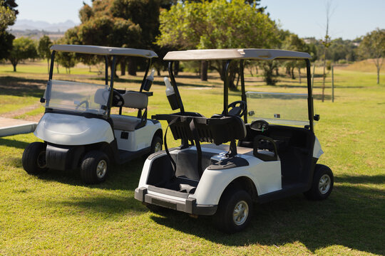 Two golf baggies standing on a golf field on a sunny day