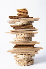 The crispbreads are stacked. Healthy crispy bread on a white background. Vegetarian and diet food. Close-up photo.