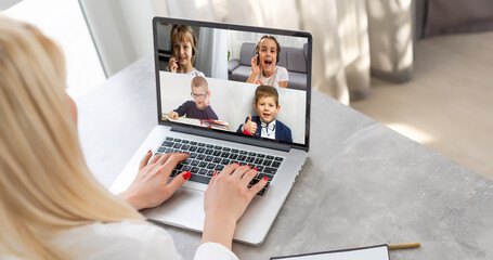 laptop with videoconference children classmates stands on the table