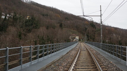 Railway bridge with small station in distance
