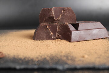 macro day chocolate two large chopped pieces of chocolate on a black background close-up