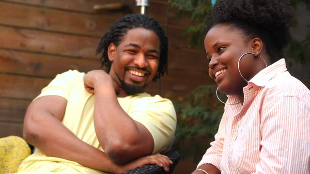 smiling couple having a great time and smiling outdoor in backyard