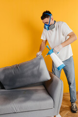 Dry cleaner's employee removing dirt from furniture in flat, closeup. Cleaning company using professional equipment.