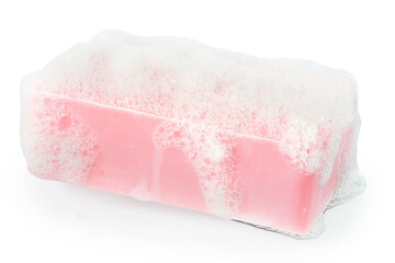 Obraz na płótnie Canvas Bar of pink soap in the foam close up isolated