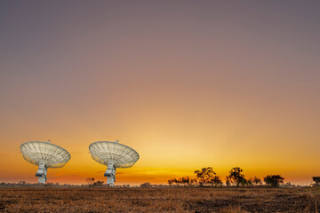 high technology large satellite dish radar or radio telescopes station in meadow or field at...