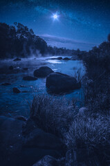 Rocky river in a light of rising moon