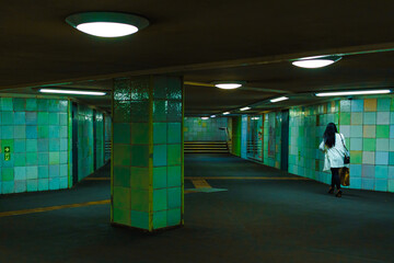 person walking in underground passage 