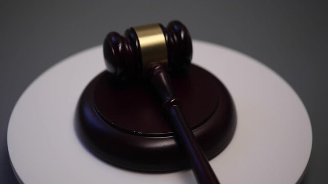 Wooden judge gavel spinning on a table.