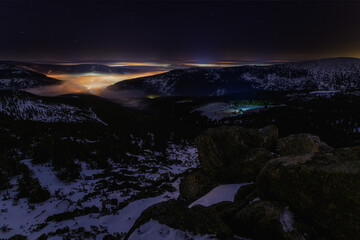 night snowy valley with fog and stars