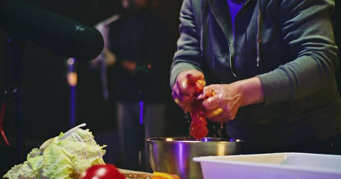 Crop sound designer squeezing vegetables over bowl