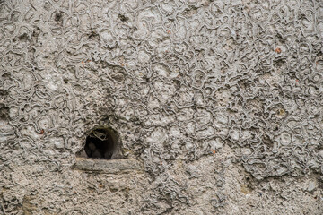 The texture of the old stucco on a brick wall.
