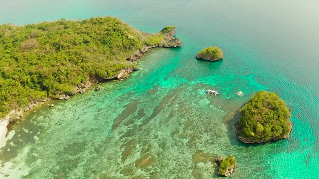 Clear turquoise water in a lagoon with rocky islands and corall reef from above Boracay, Philippines. Summer and travel vacation concept.