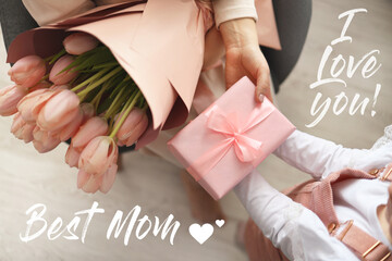 Child's hands hold beautiful pink gift box with ribbon and pink tulip flower. Top view, close-up....