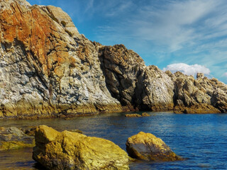 Seascape with large rocks on the coast of Ceuta, Spain.