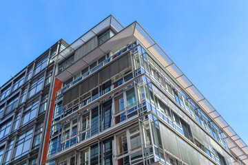 Low angle shot of an angular modern glass building in Kiel, Germany