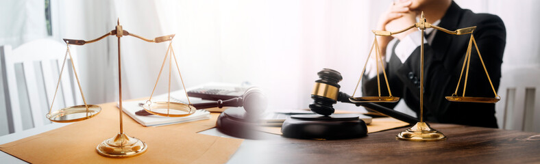 Justice and law concept.Male judge in a courtroom with the gavel, working with, computer and...
